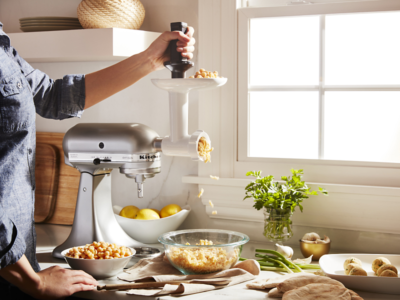 Woman grinding chickpeas with a KitchenAid® Food Grinder