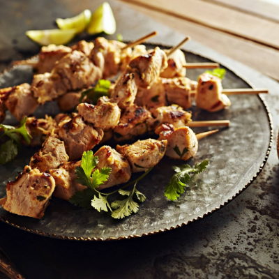 Pile of Thai chicken skewers on a plate