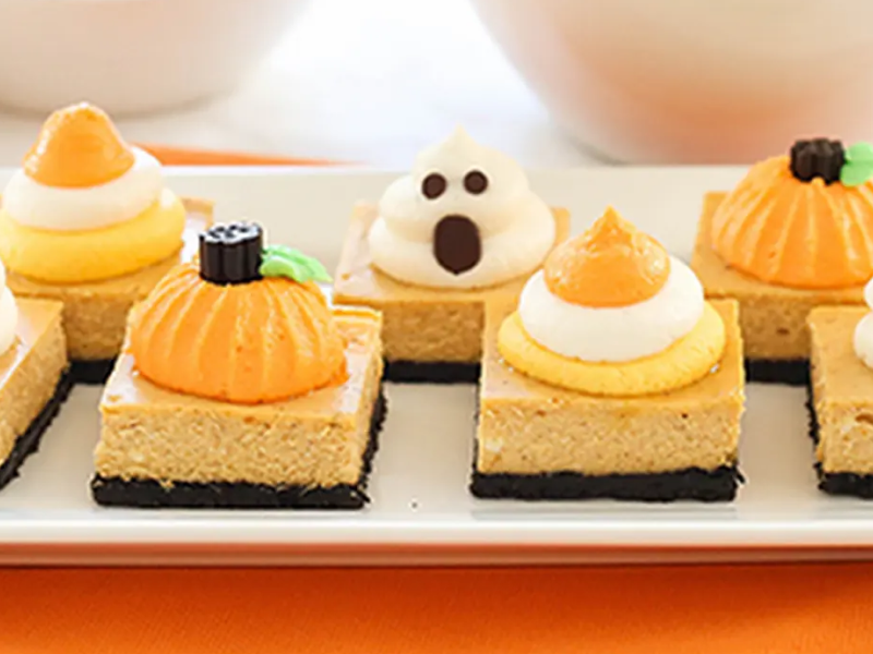 Pumpkin cheesecake bars with ghost, pumpkin and candy corn pipe work