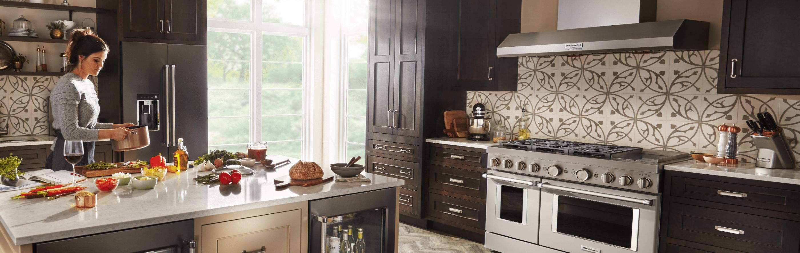 Modern kitchen featuring KitchenAid® stainless steel range and range hood
