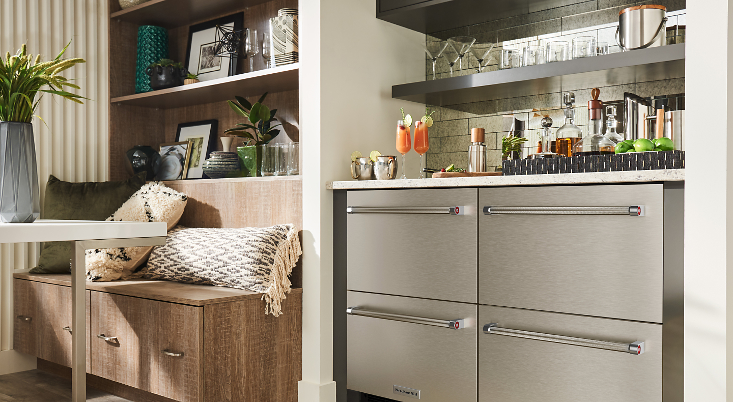 Stainless steel KitchenAid® undercounter refrigerator drawers under a wet bar