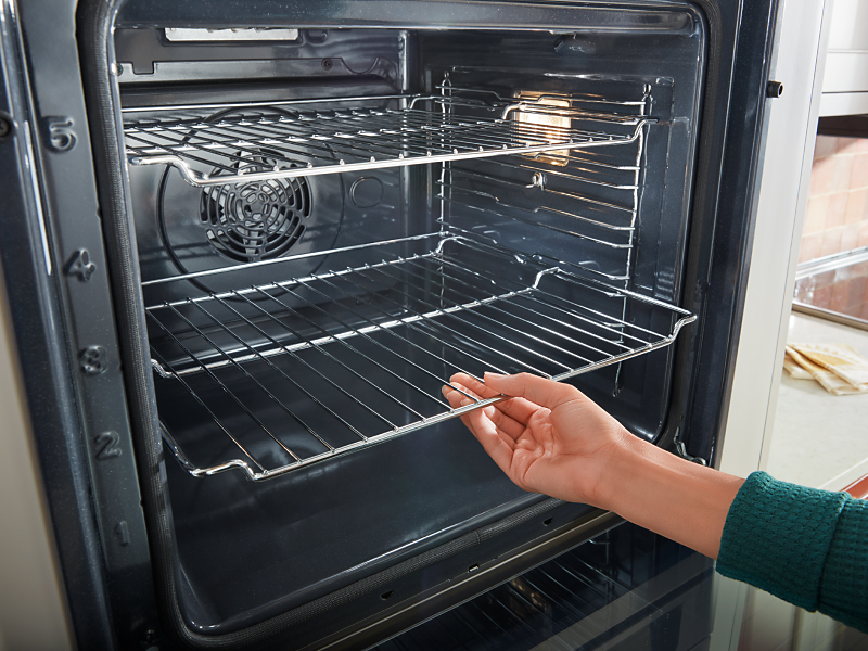 Person removing racks from oven