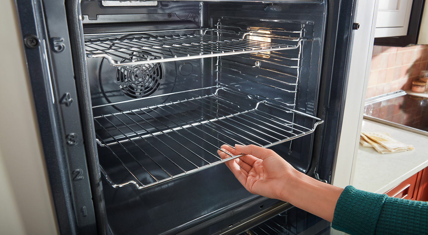 Person removing racks from oven