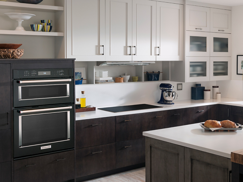 Black stainless steel KitchenAid® wall ovens in a black and white kitchen