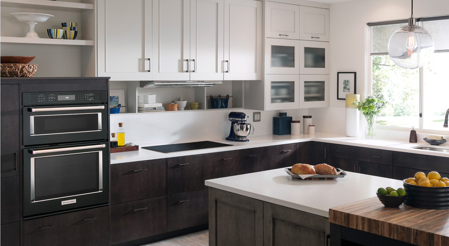 Black stainless steel KitchenAid® wall ovens in a black and white kitchen
