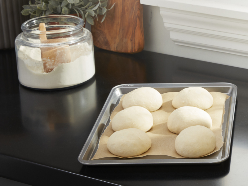 Raw dough balls on a prepared baking sheet