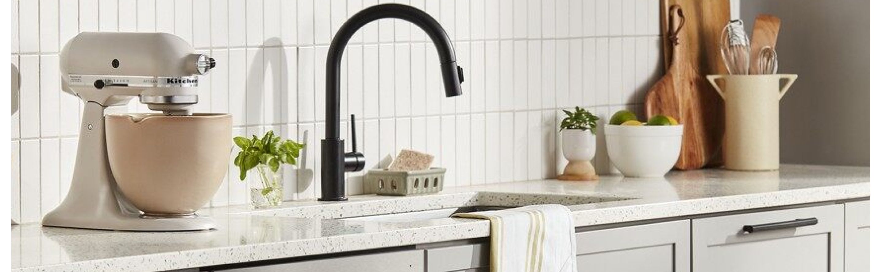 KitchenAid® stand mixer on a countertop next to a kitchen sink