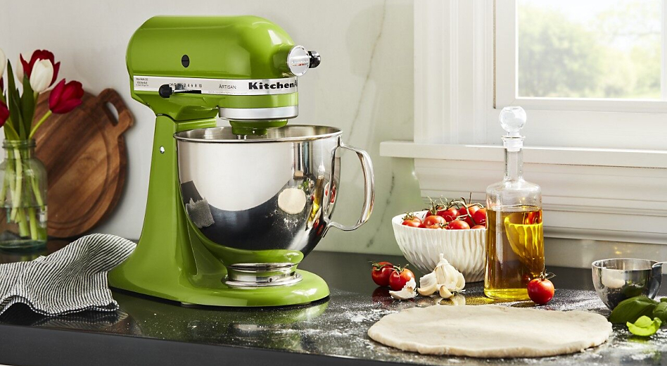 Green stand mixer on counter with rolled out dough