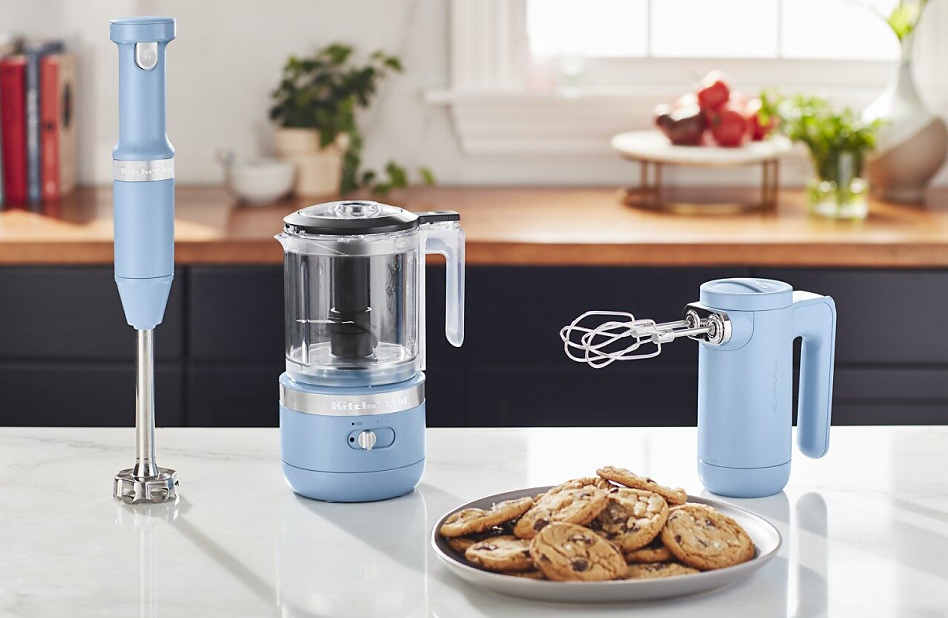 Blue KitchenAid® cordless collection appliances on counter with cookies Blue KitchenAid® cordless collection appliances on counter with cookies