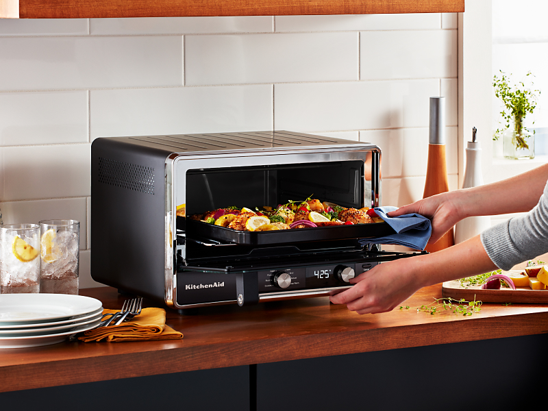 A fresh meal cooking in a KitchenAid® toaster oven