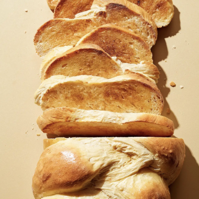 Sliced braided challah bread on a countertop