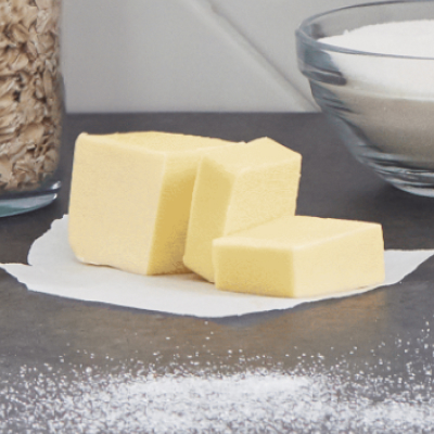 Butter on countertop cut into cubes with other ingredients
