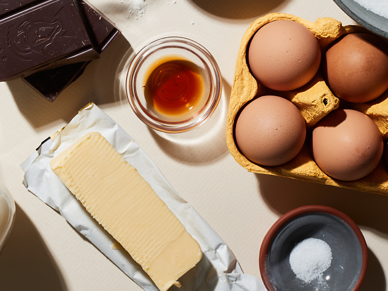 Birds-eye view of eggs, butter and other ingredients on counter