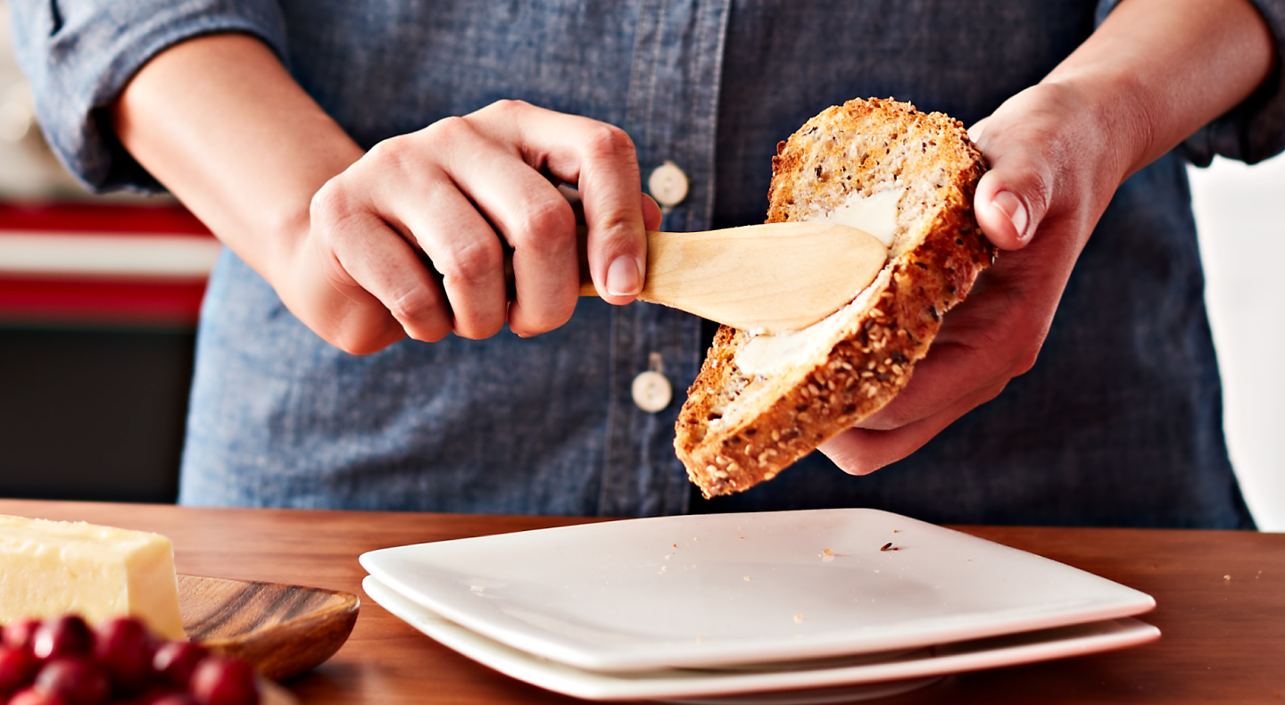 Person buttering a slice of bread