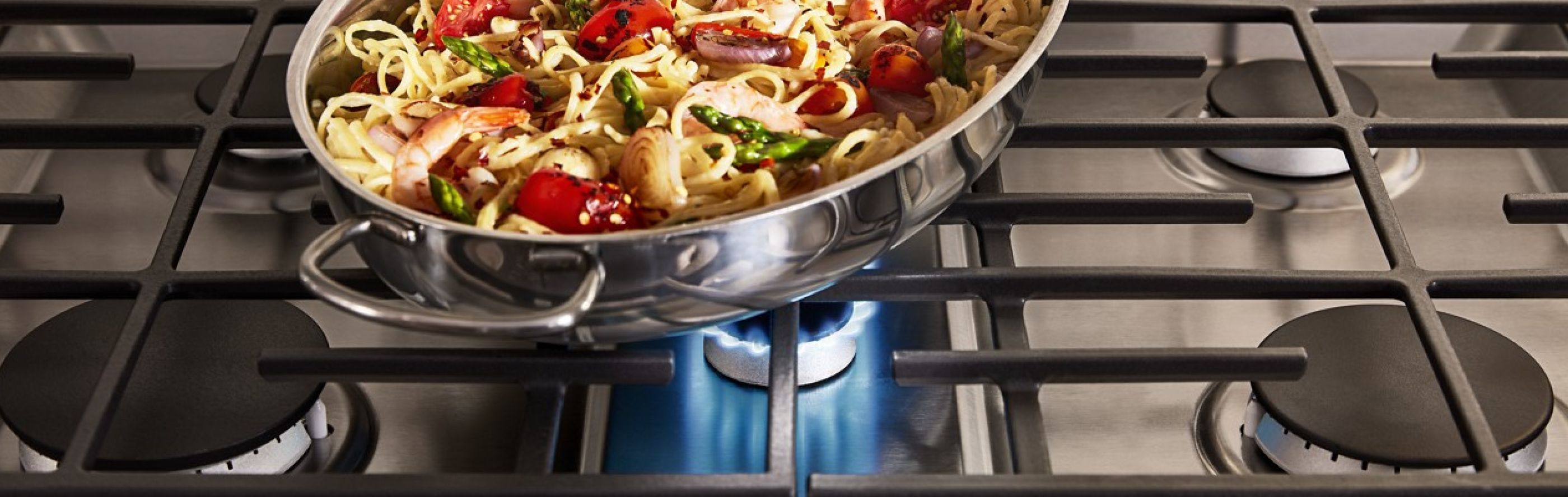 Pasta in a pan on a gas stove burner