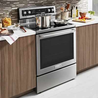 A KitchenAid® convection oven with pasta ingredients nearby.
