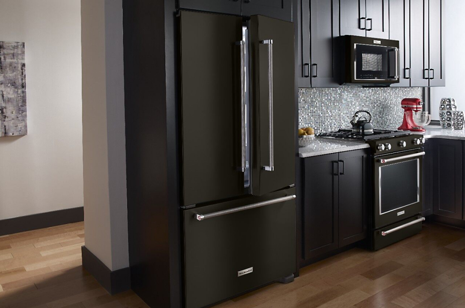 Black stainless steel refrigerator style in dark, modern kitchen