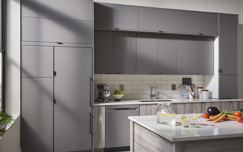Minimal kitchen with gray cabinets and panel-ready refrigerator