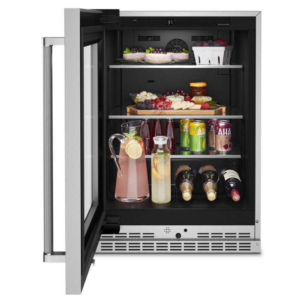 Open undercounter refrigerator with appetizers and drinks inside