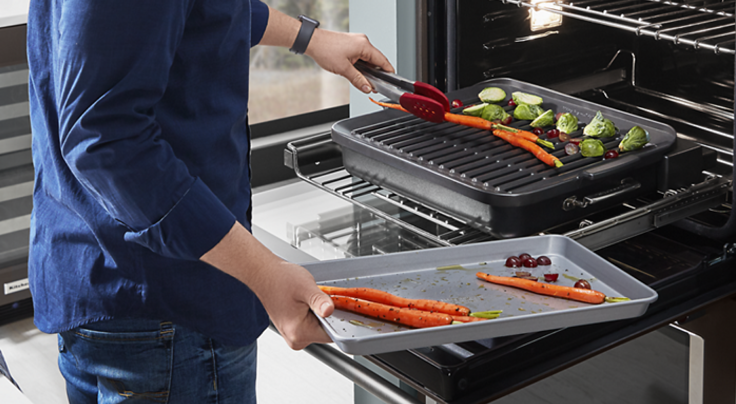 Person grilling vegetables using a KitchenAid® Smart Oven + Grill Attachment