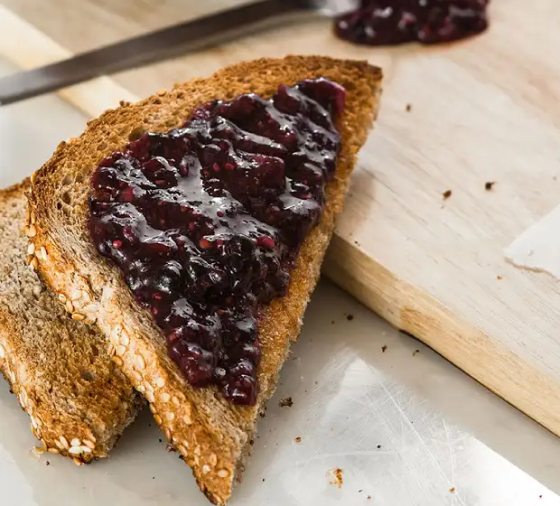 A slice of toast spread with jam
