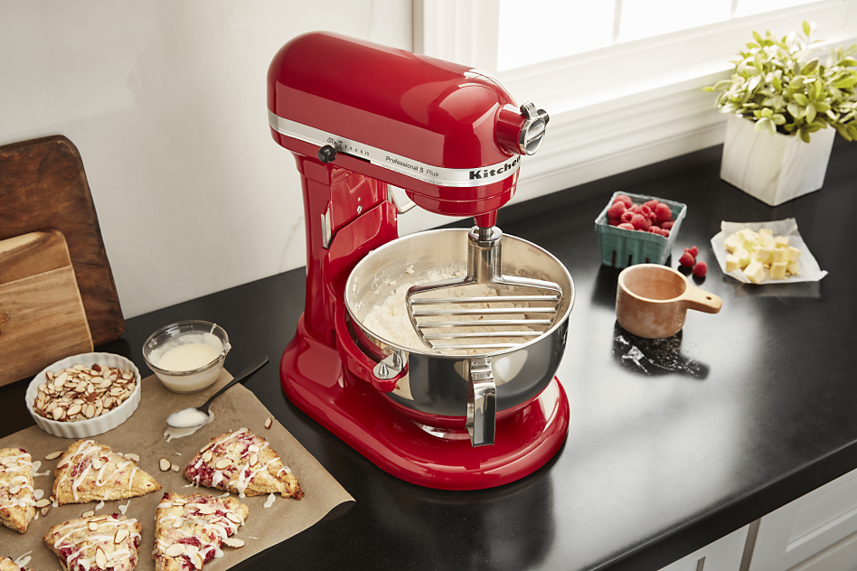 Red KitchenAid® stand mixer mixing pastry dough on countertop