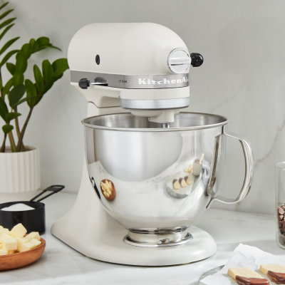 White KitchenAid® stand mixer with ingredients on counter