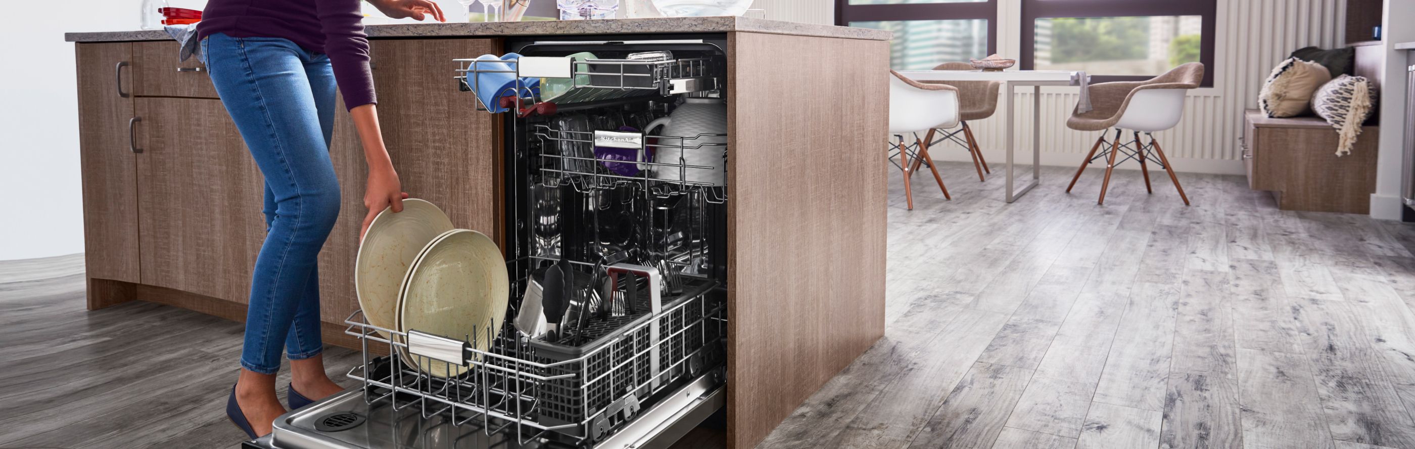 Woman loading dishes into a dishwasher