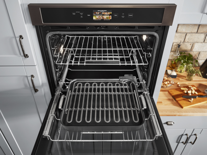 An open KitchenAid® wall oven in a modern oven.