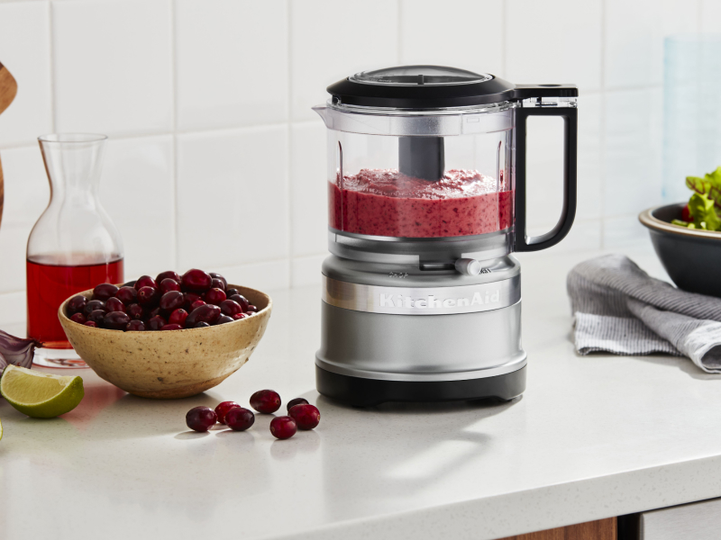 KitchenAid® food processor with pureed cherries and bowl of whole cherries