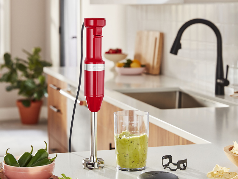 KitchenAid® hand blender next to green smoothie on countertop