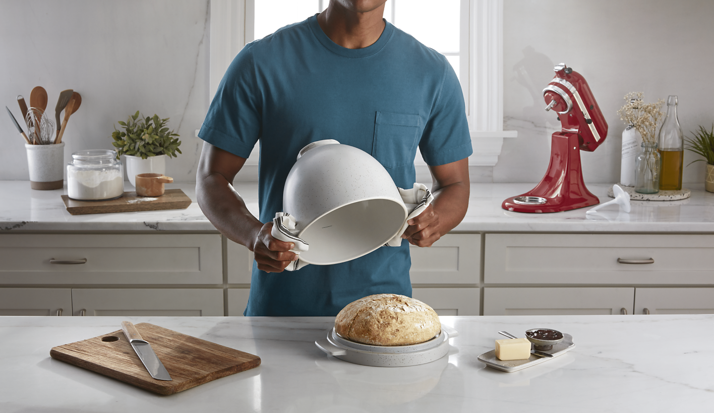 Person removing bread from a KitchenAid® bread bowl