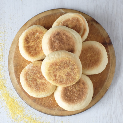 Wooden dish topped with english muffins