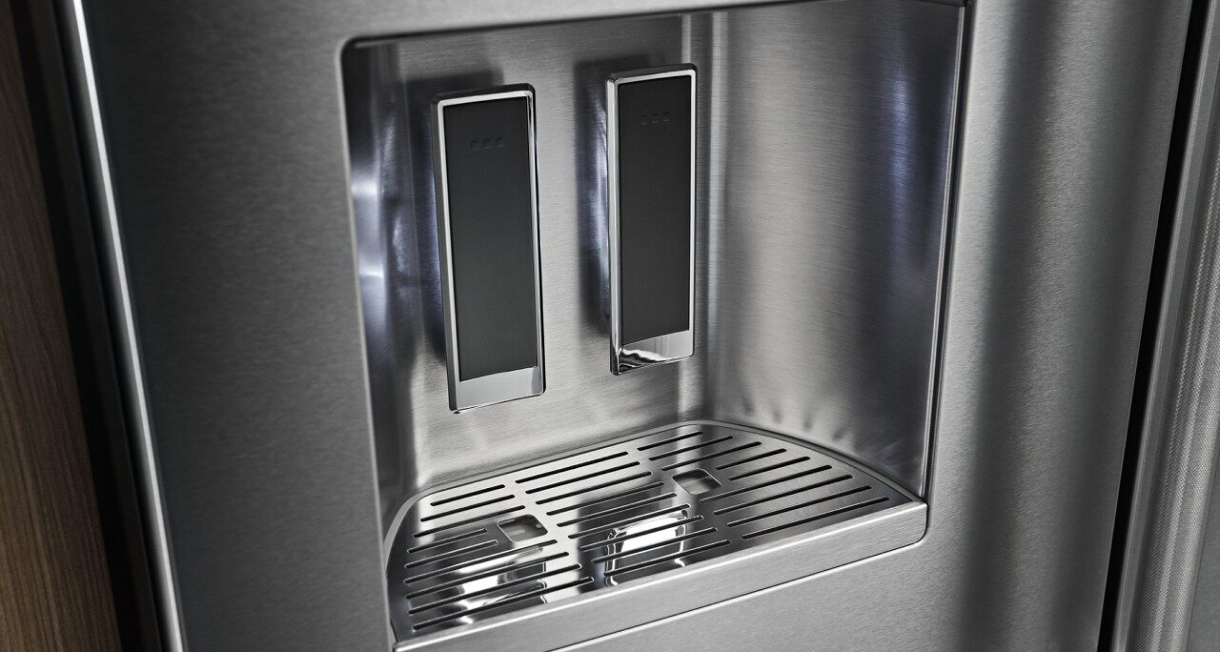 External water dispenser illuminated on the KitchenAid® French Door Bottom Mount Refrigerator.
