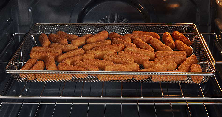 Mozzarella sticks cook in a fry basket on a rack in a Maytag oven