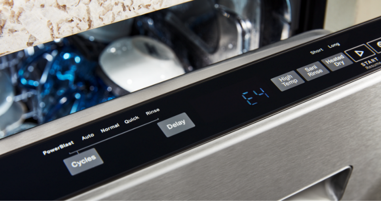 Close-up of a Maytag Top Control Dishwasher. The door is ajar and these buttons are visible: 'Cycles', 'Delay','High Temp', 'Sani Rinse', 
                'Heated Dry' and 'Start'. Inside the dishwasher are bowls and other items.  