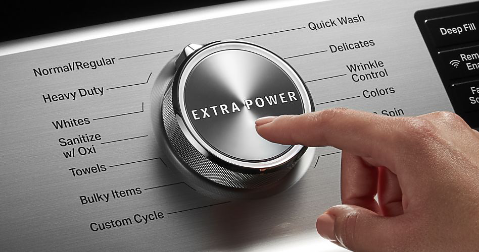 A finger pressing the Extra Power button on a Maytag washer