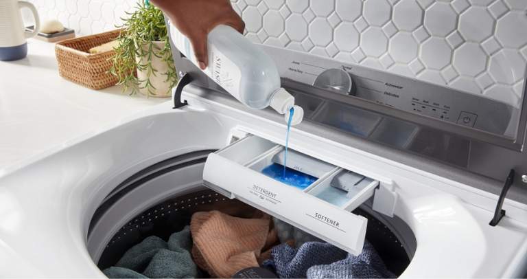 A Maytag washing machine is seen washing various clothing items