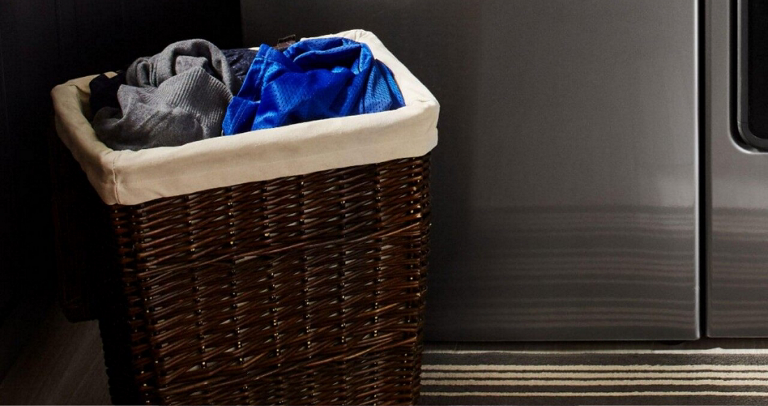A laundry bin with various clothing items 