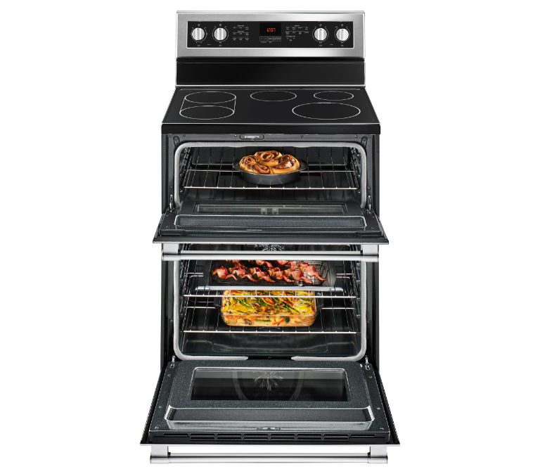  A Maytag Double Oven with the doors open. A dish cooks on each rack in each oven. 
