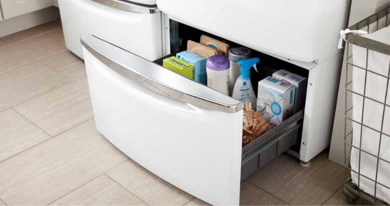 Several laundry items are seen in the open pedestal drawer.