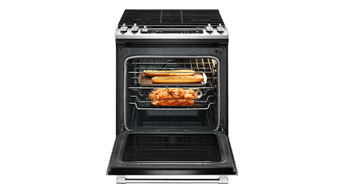 Photo featuring a Maytag gas cooktop with various food items in the oven