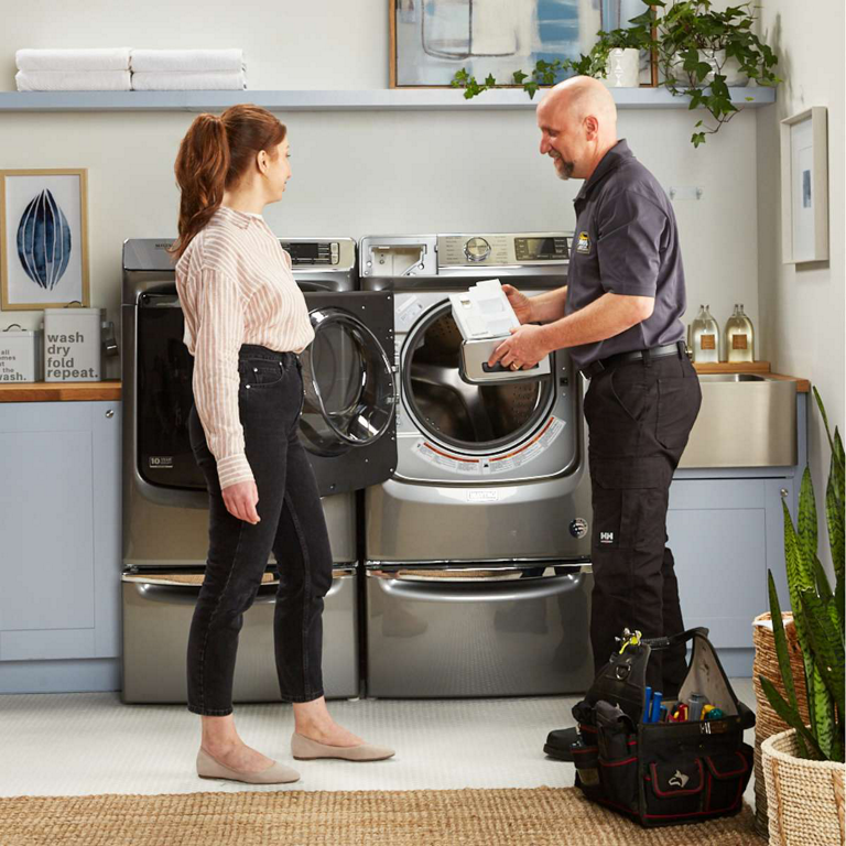 Appliance repair professional consulting with a home owner