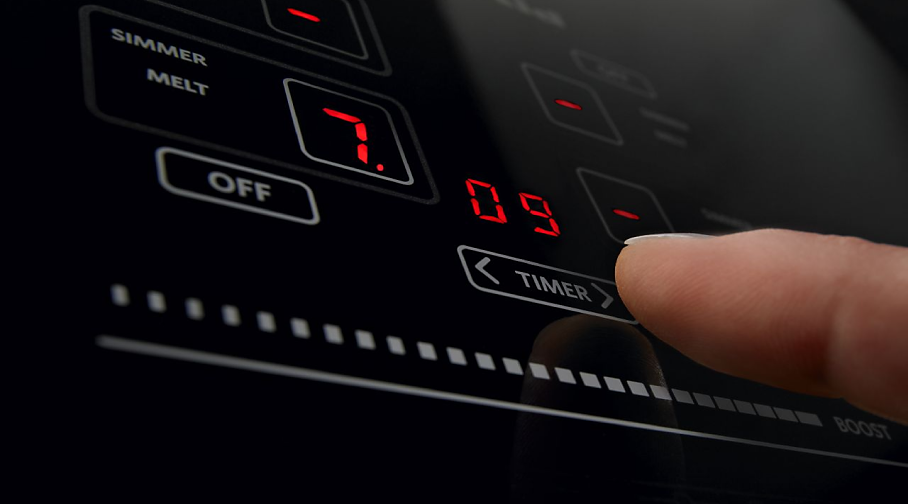 A close up image of a KitchenAid®  induction cooktop control pad.