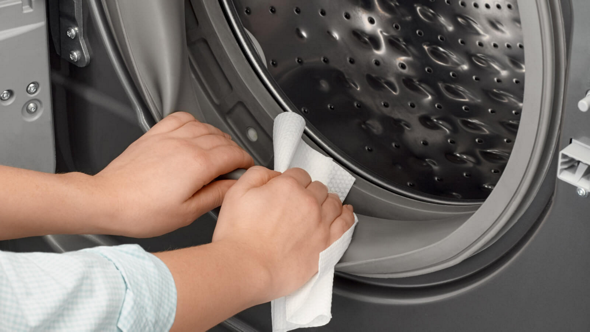 Cleaning the door seal of a Maytag® front-load washing machine.