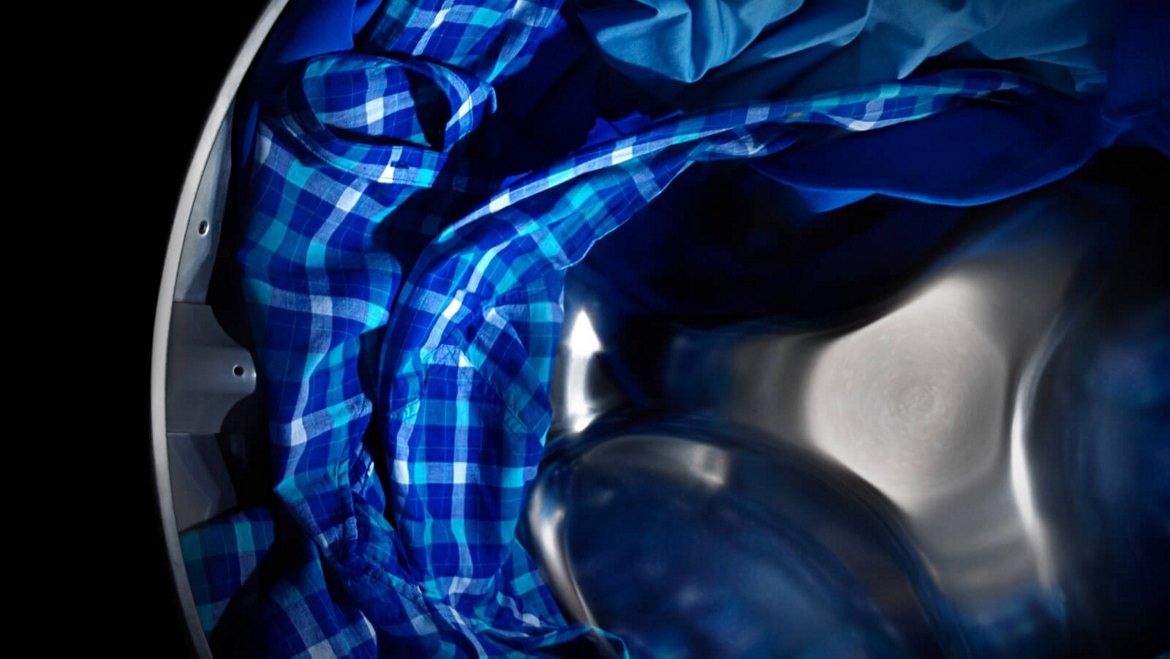 Maytag® dryer tumbling blue clothes.