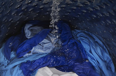 Internal view of a Maytag® washer filling with water.