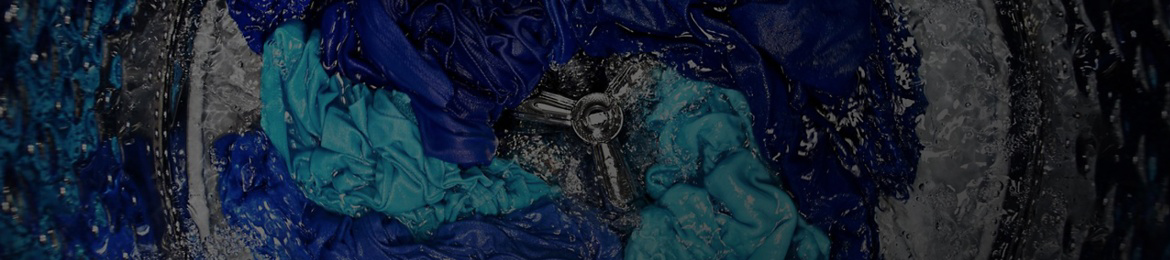 Blue clothes being washed in a Maytag® top-load washer.