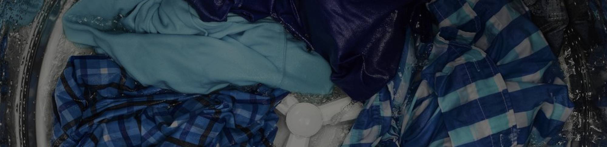 Internal view of a Maytag® washing machine that's washing clothes.