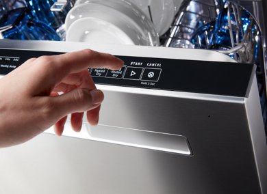 Person selecting a dishwasher cycle